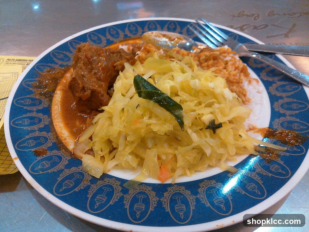 Plate of food with meat, rice, and cabbage