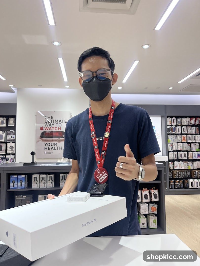 Salesperson with MacBook Air Box