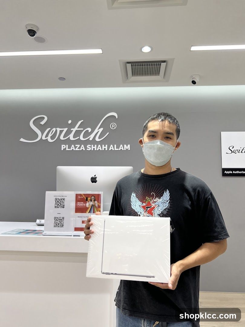 Man holding a laptop in a store