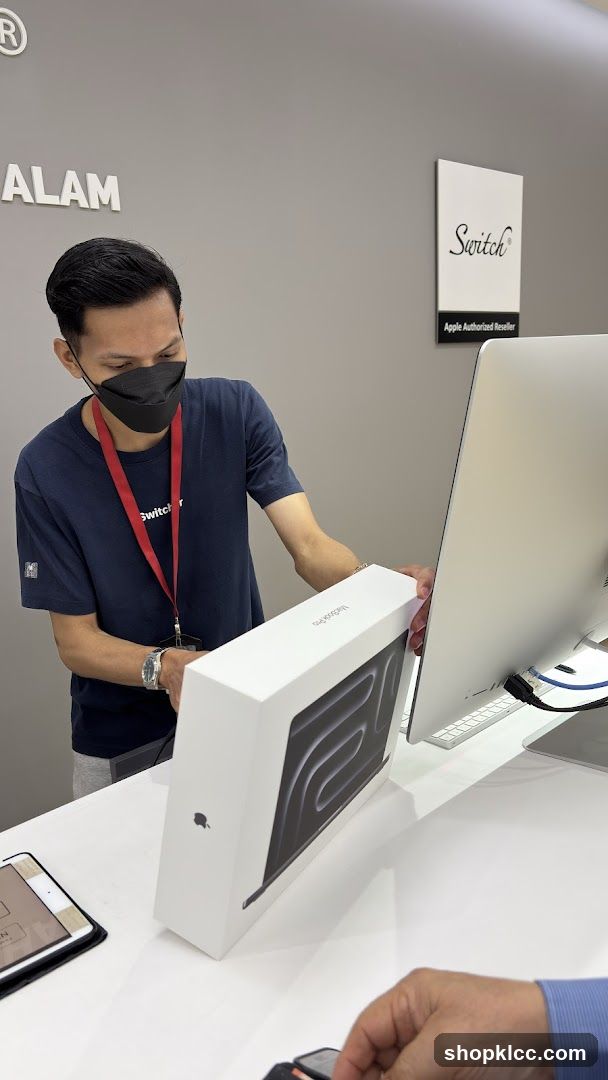 Salesperson with MacBook Pro Box