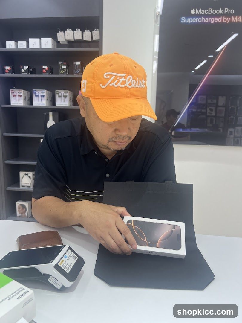Man holding an iPhone box in a store
