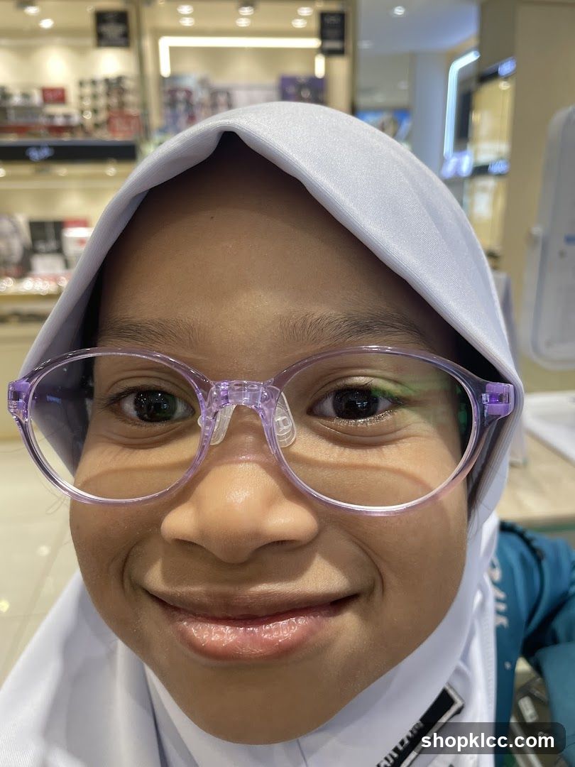 Young girl trying on glasses
