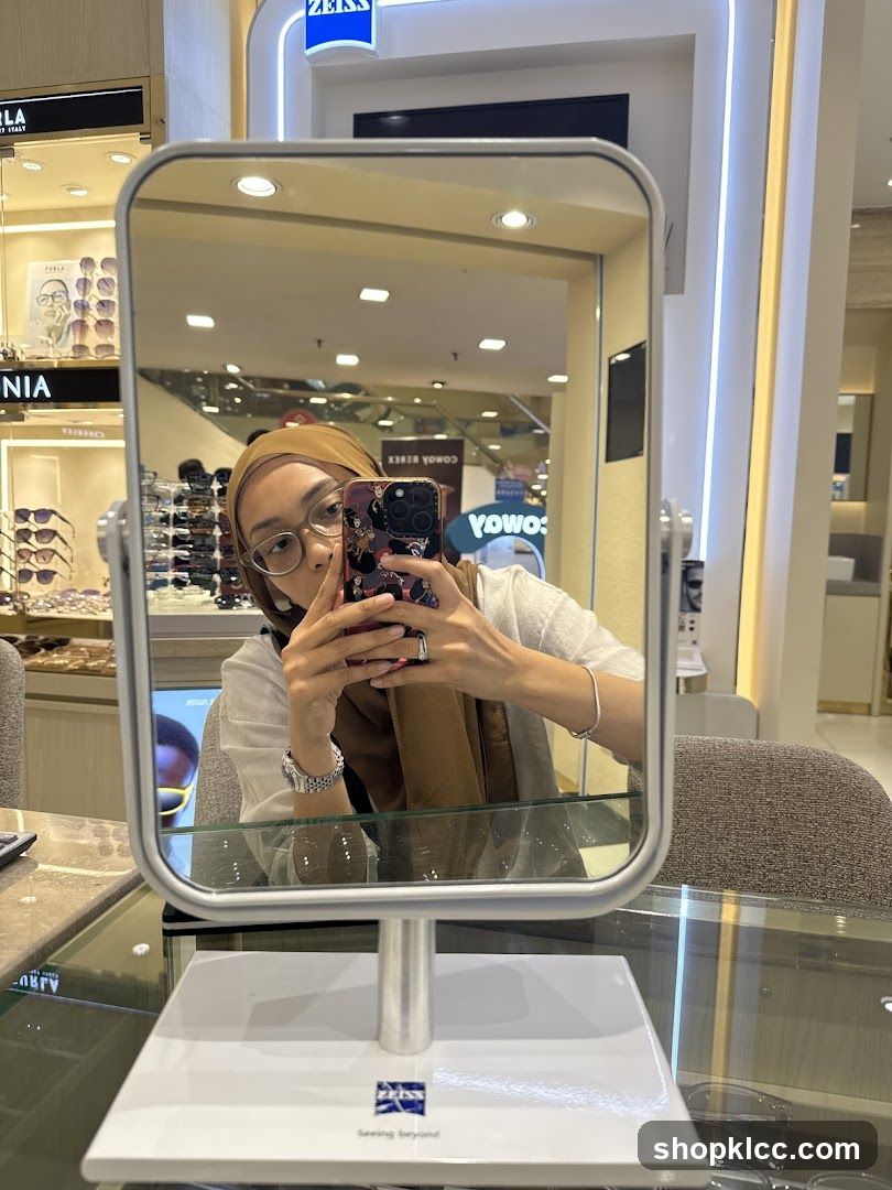 Woman taking a selfie in a mirror at an optical store