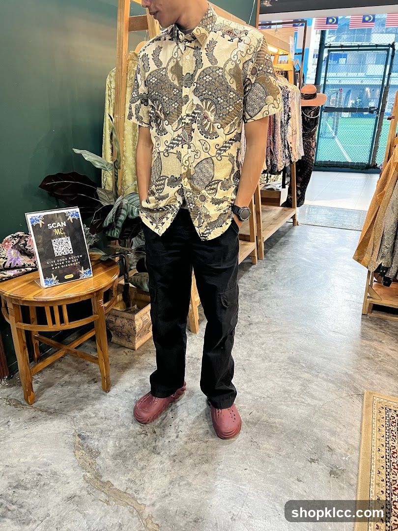 Man in patterned shirt and black pants