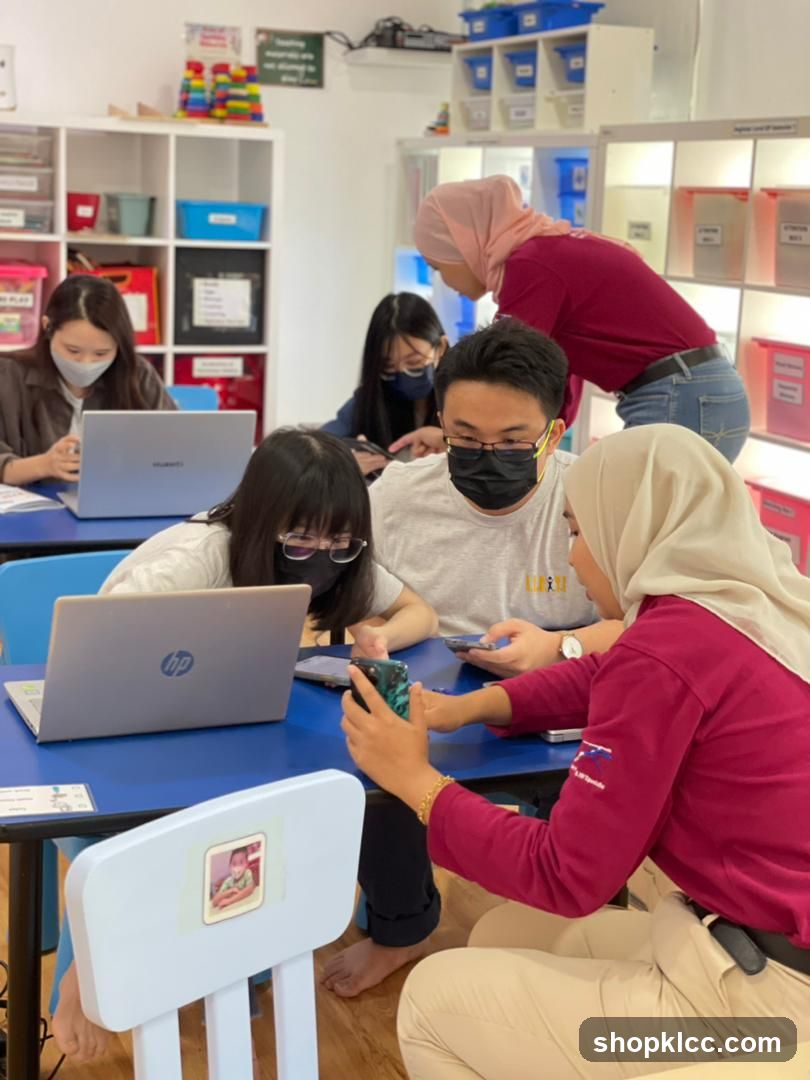 People using laptops and phones in a classroom
