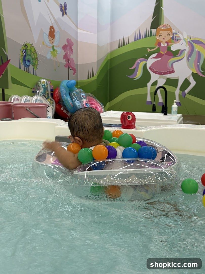 Baby in a pool with colorful balls