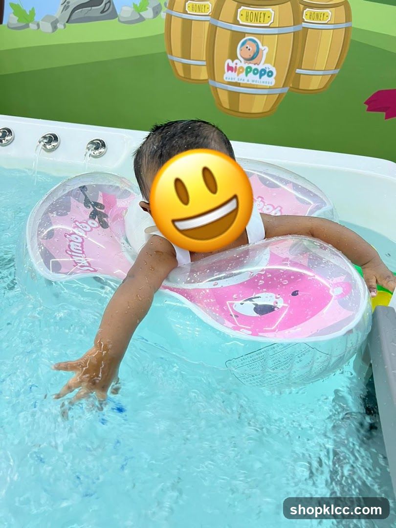 Baby in a pool with a float