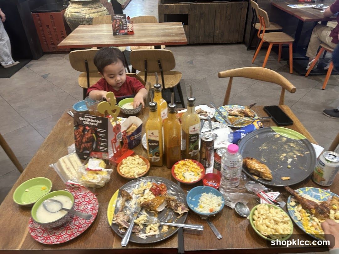 Messy Table with Food and a Child