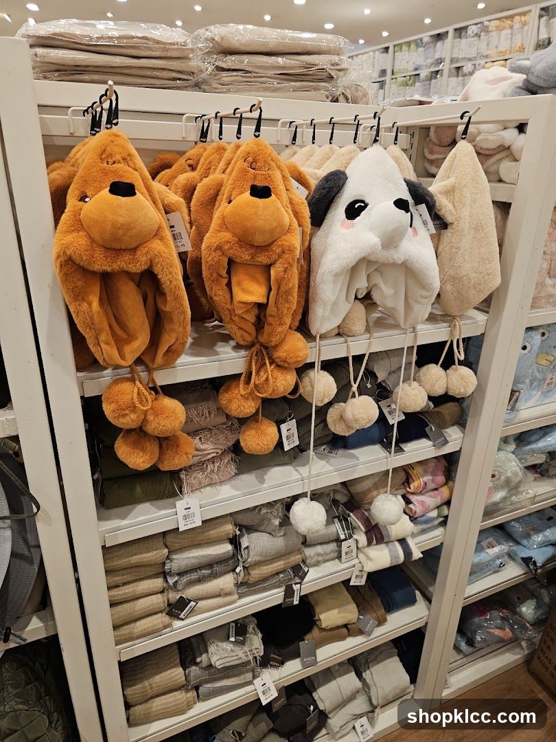 Animal-themed hats and folded textiles on display shelves
