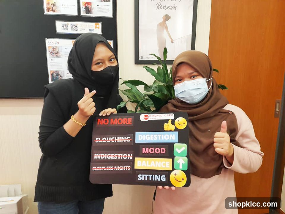 Two women holding a sign