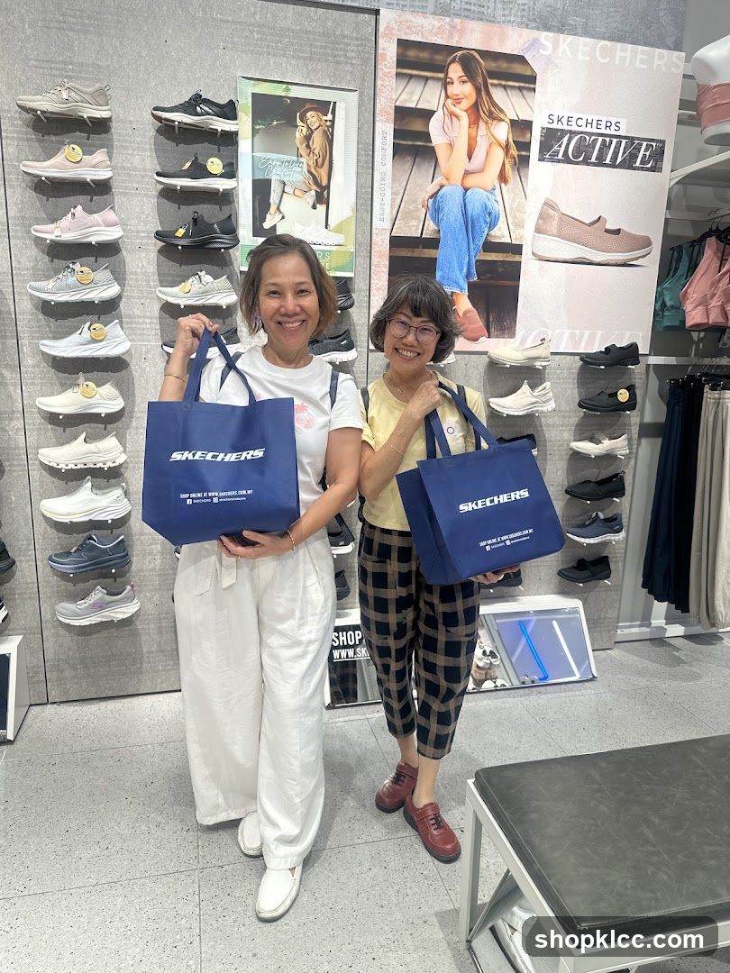 Two Women Holding Skechers Shopping Bags