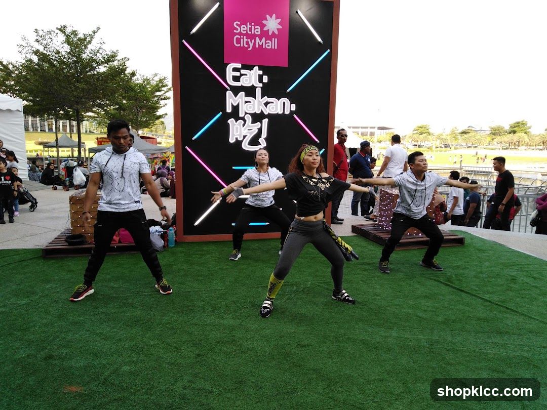 People dancing in front of a mall advertisement