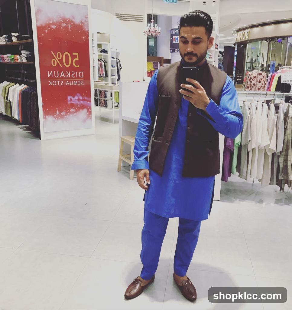 Man taking a selfie in a clothing store
