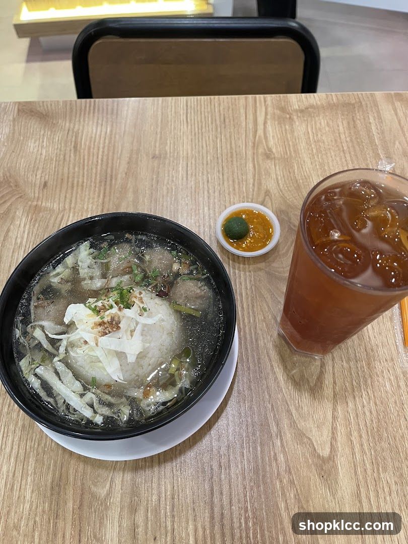 Bowl of Rice Soup with Meatballs and Iced Tea