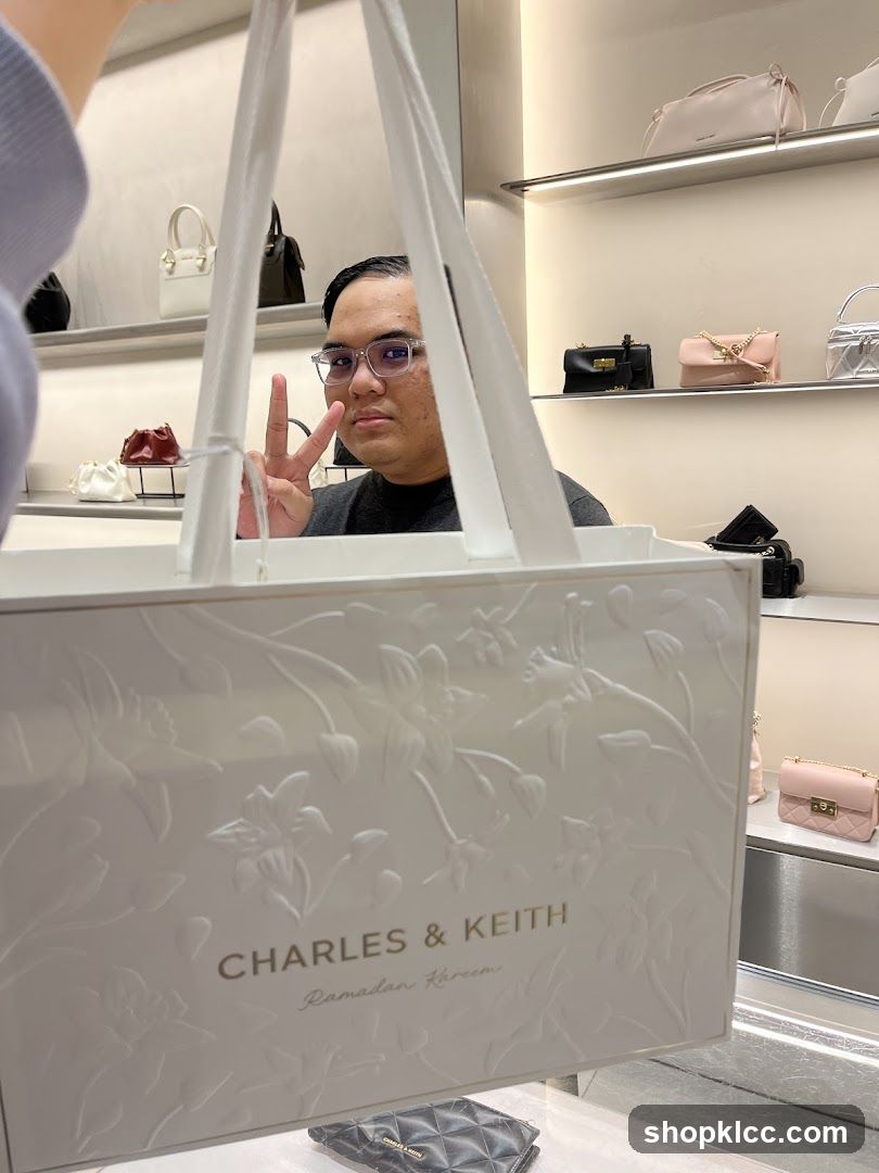 Person holding a shopping bag in a store