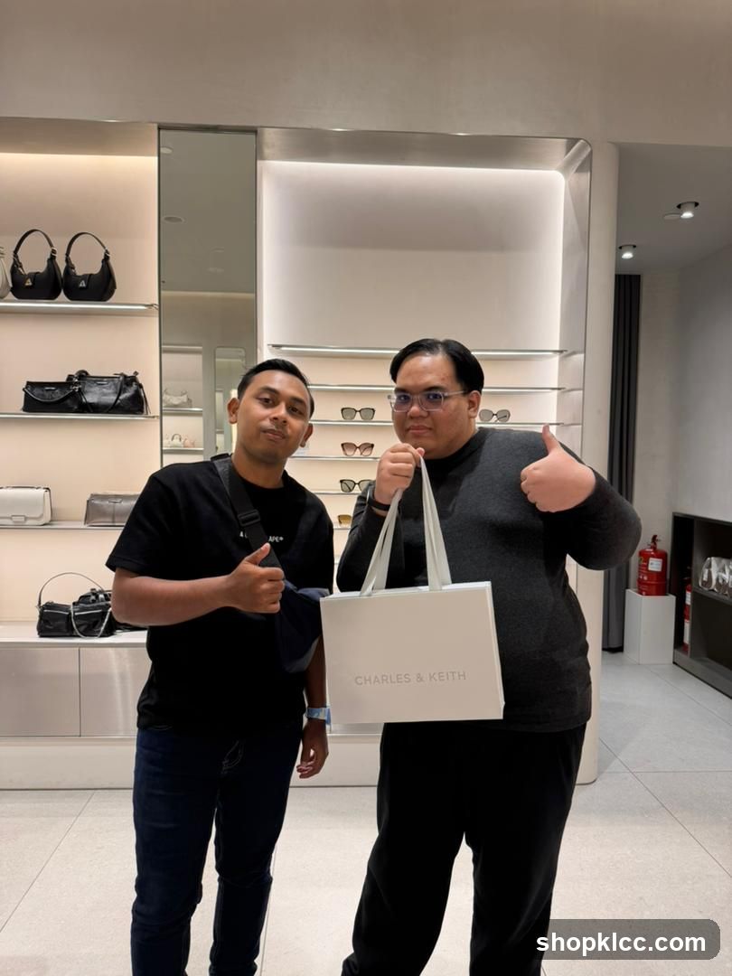 Two Men Posing with a Charles & Keith Shopping Bag