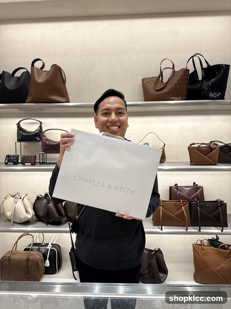 Man holding a Charles & Keith shopping bag