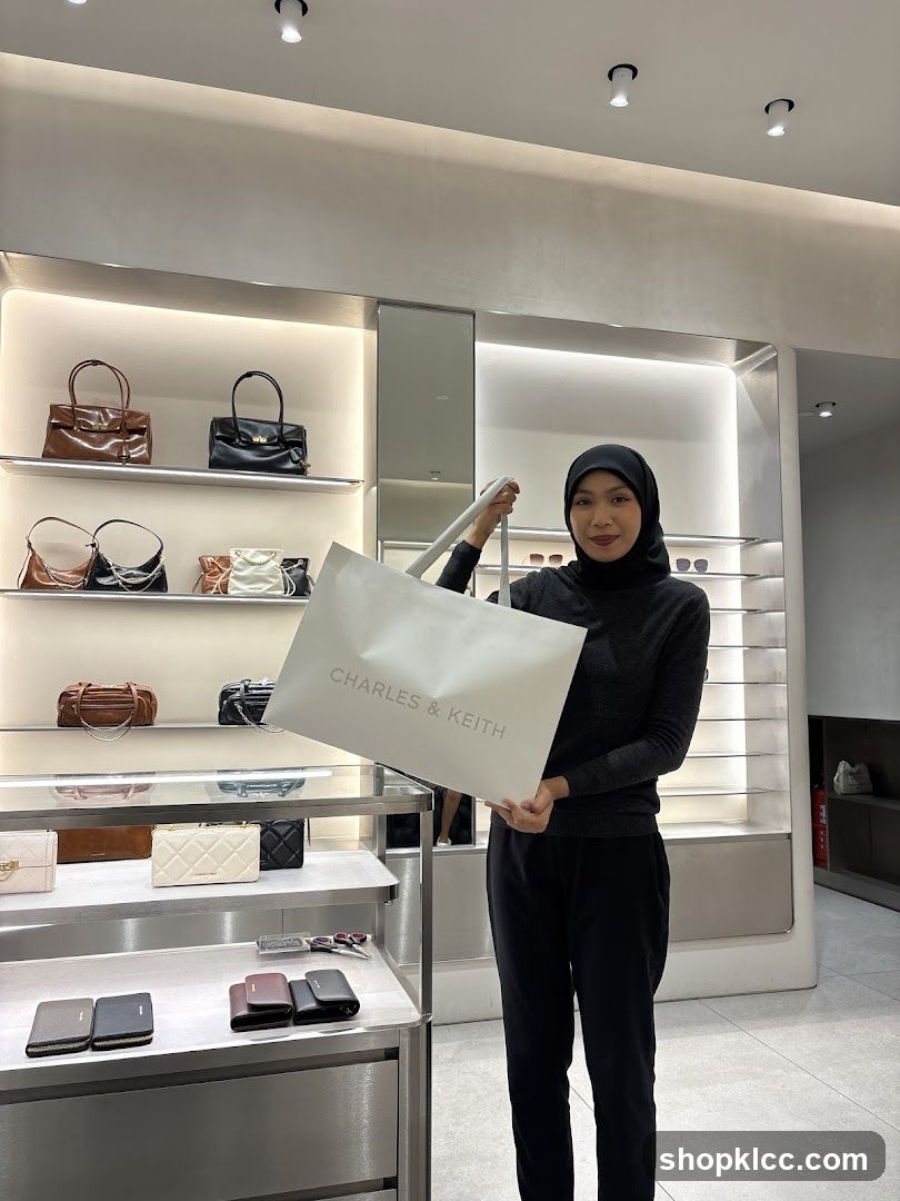 Woman Holding a Charles & Keith Shopping Bag