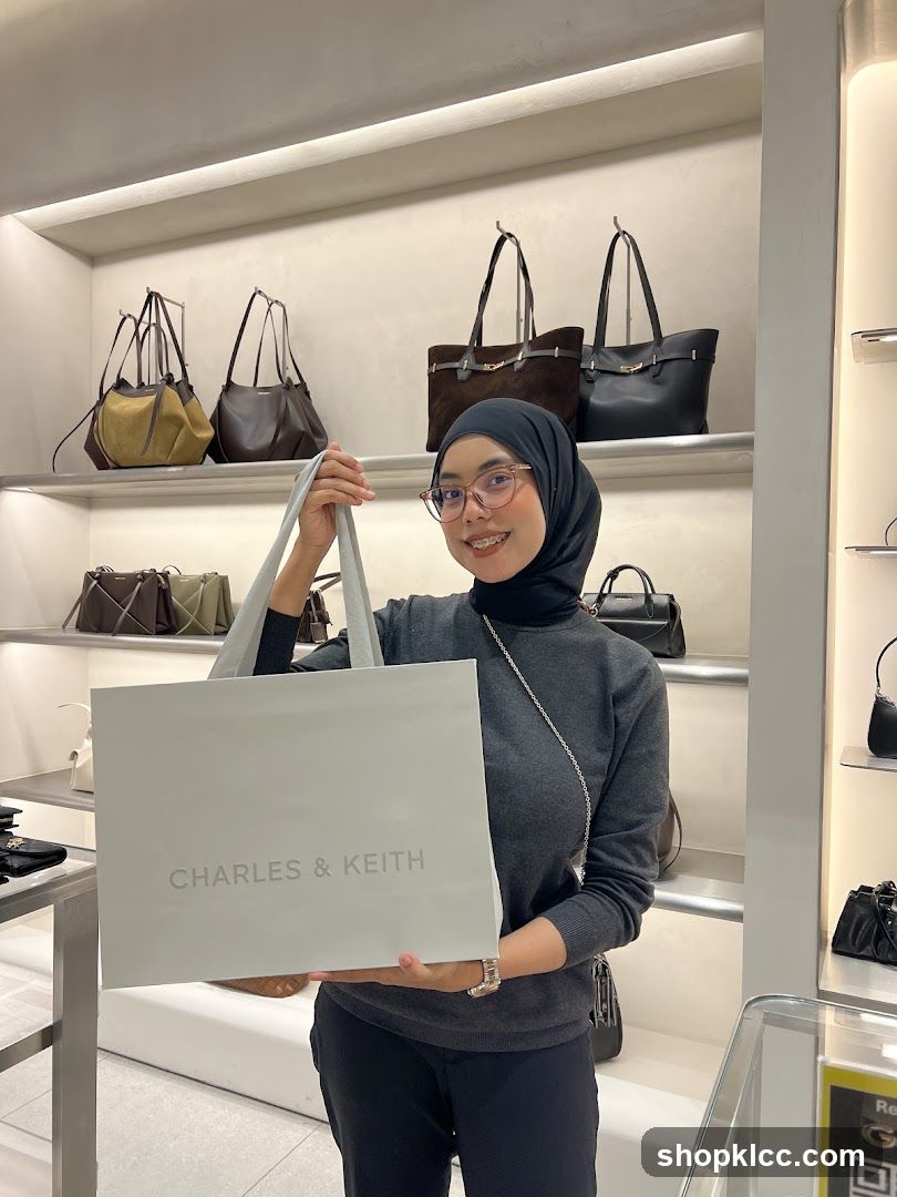 Woman holding a Charles & Keith shopping bag