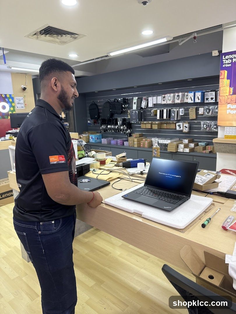Man setting up a laptop in a store