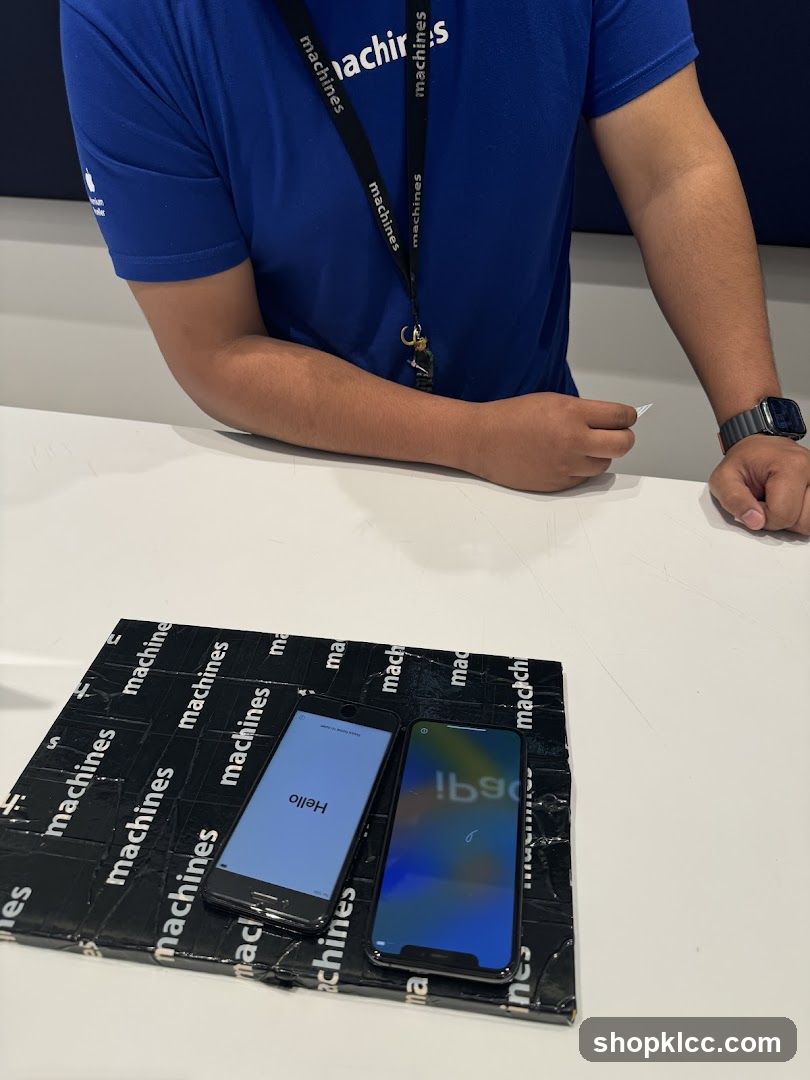 Two iPhones on a branded mat