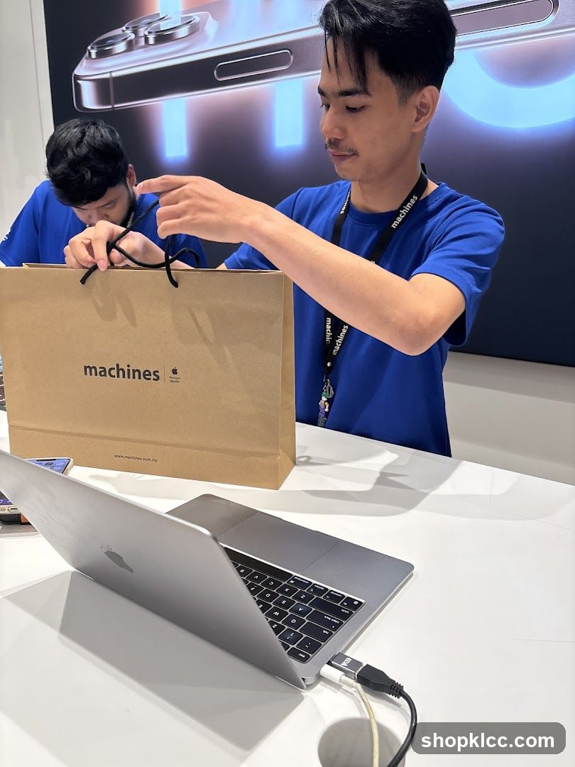 Sales associates with shopping bag and laptop