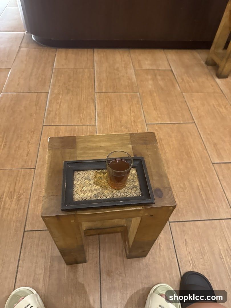 A glass of tea on a wooden stool