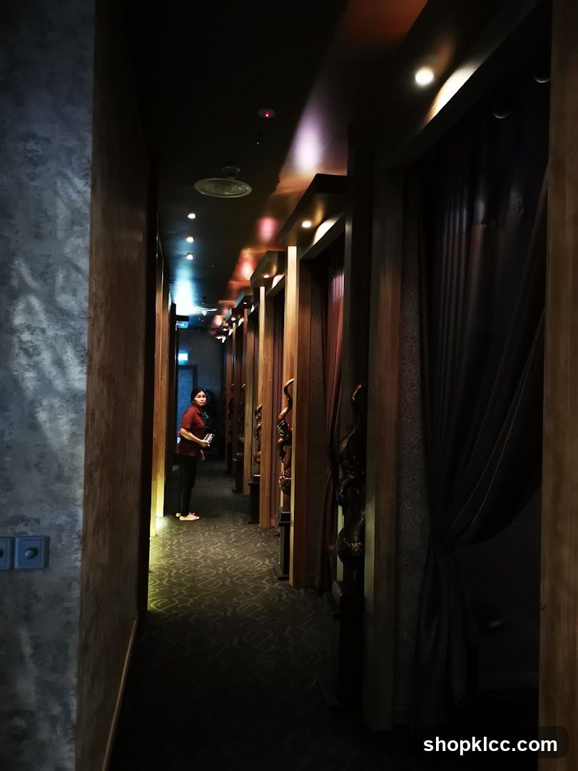 Dimly lit corridor with person standing near entrance