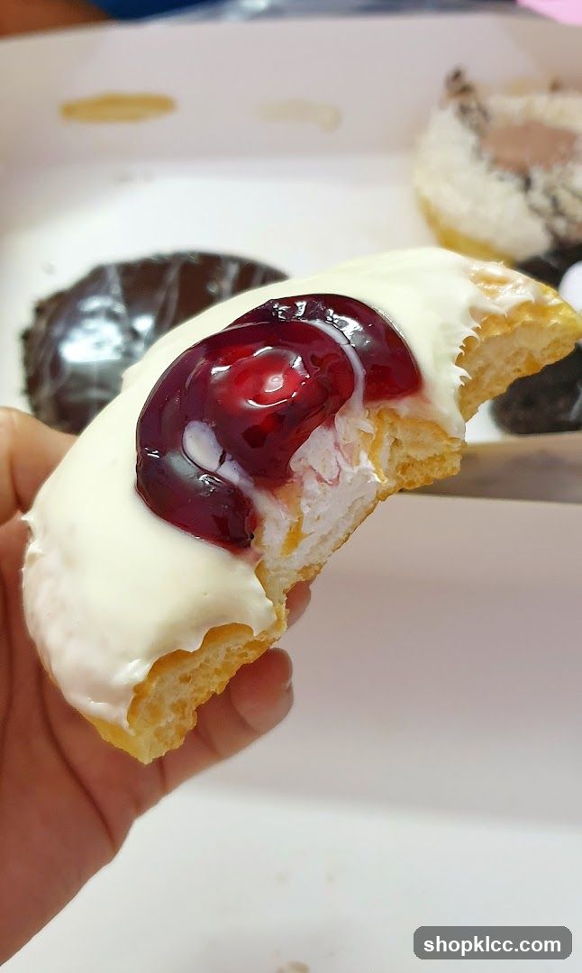 Donut with White Icing and Cherry Topping