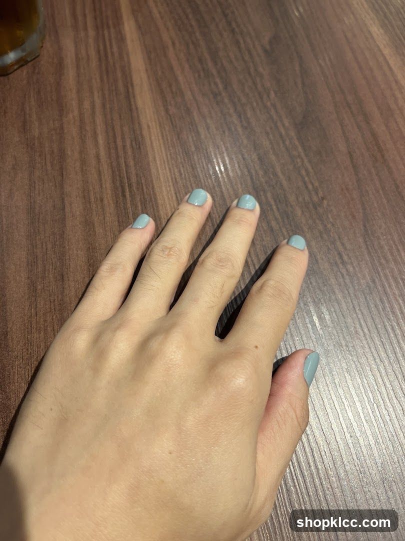 Hand with light blue nail polish