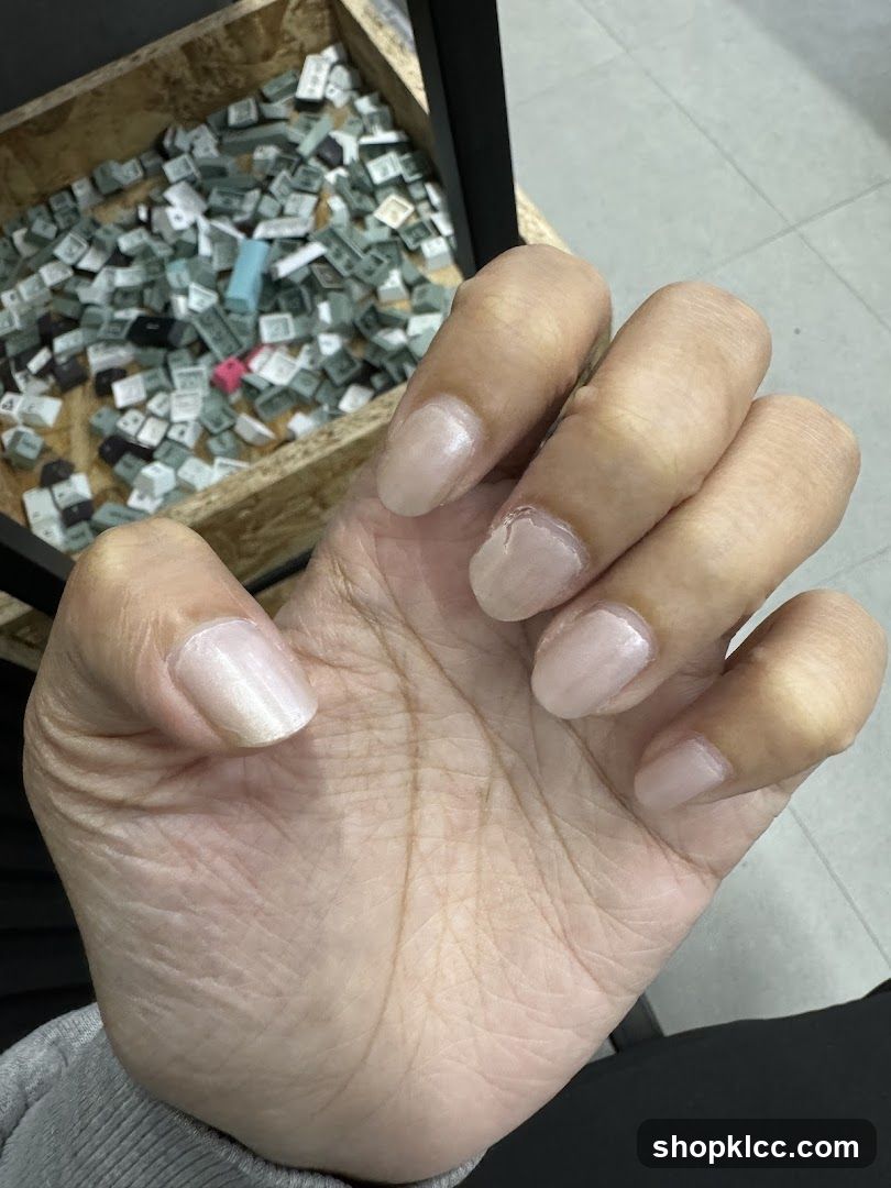 Hand with light pink nails