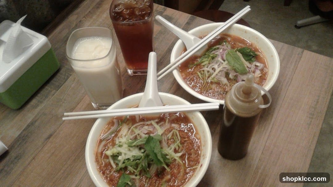 Two bowls of noodles with drinks