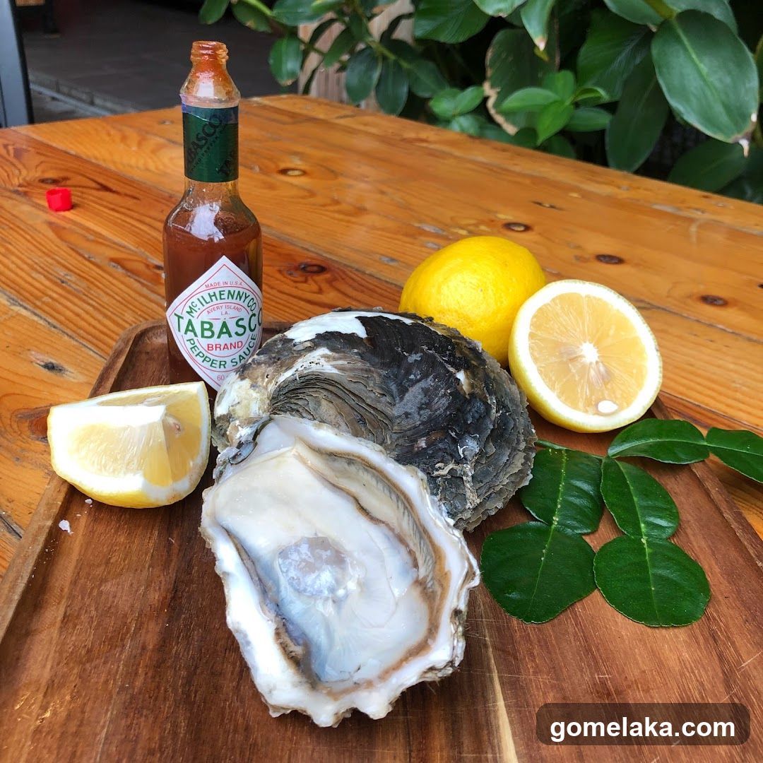 Oyster and condiments on wooden table