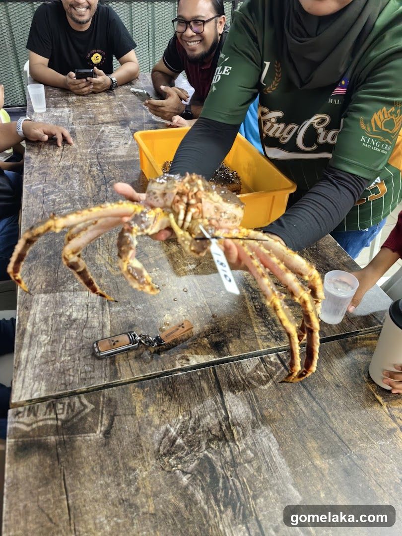 Group at dining table with large crab