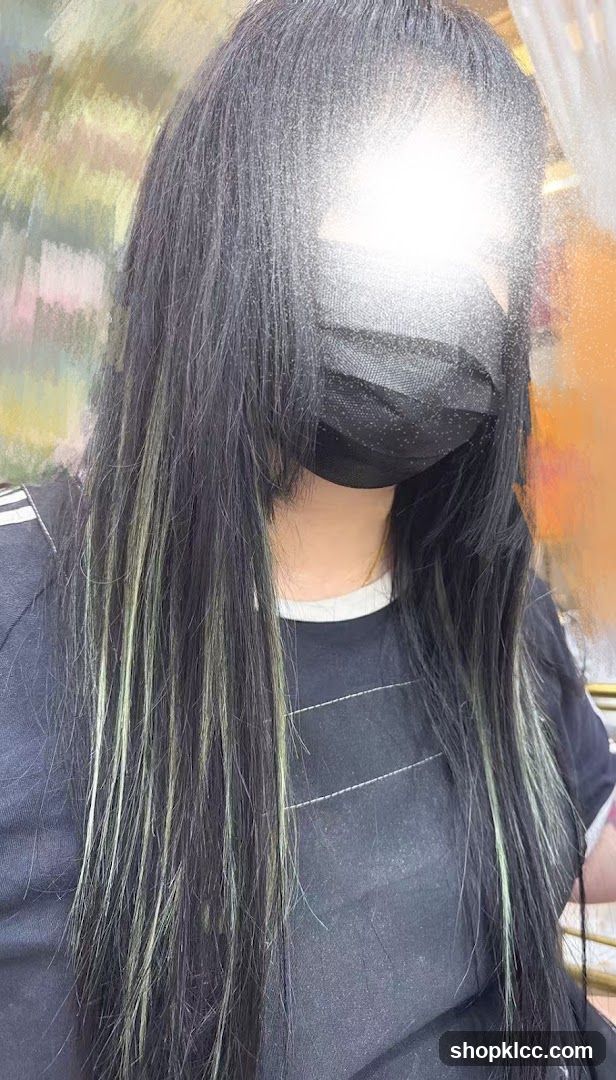 Woman with dark hair and highlights