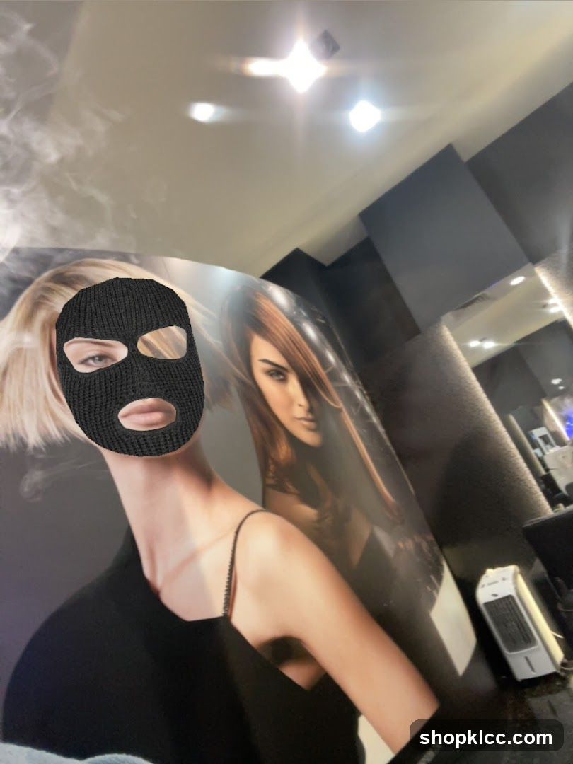 Woman in Balaclava Posing in Front of Hair Salon Posters