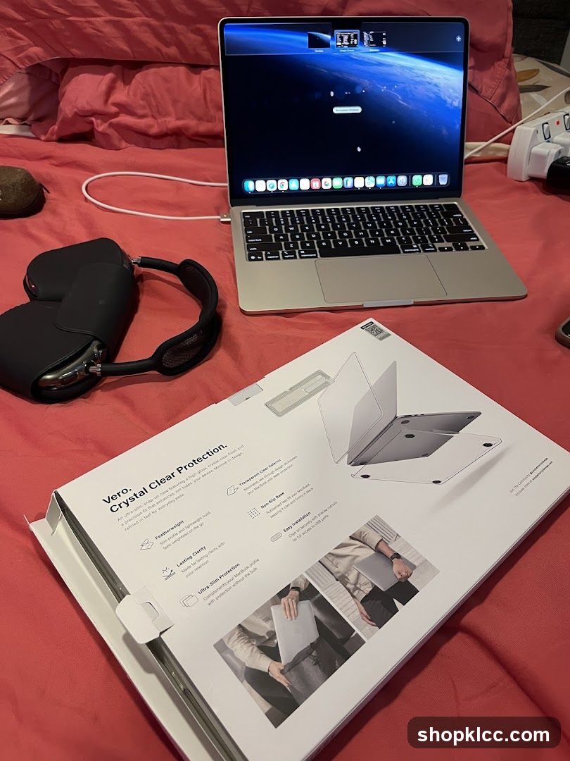 Laptop and Accessories on Bed