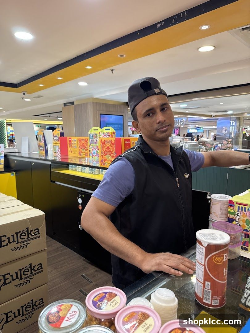 Man behind a counter with products