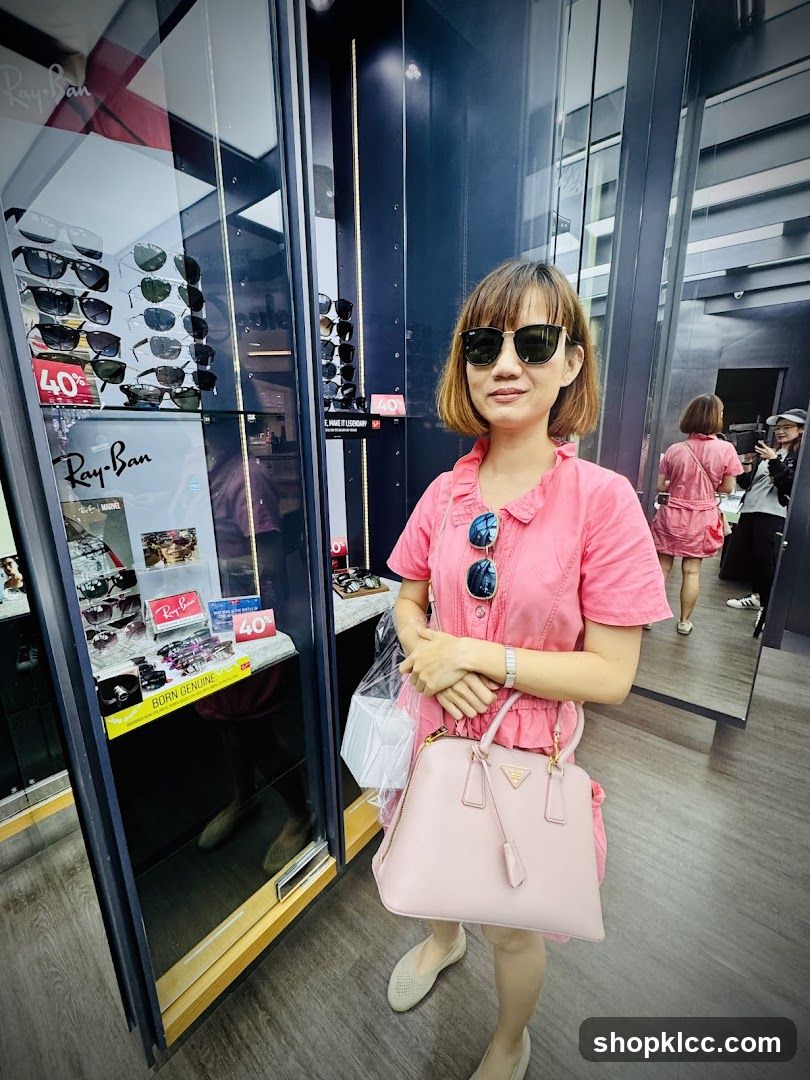 Woman in Pink Dress Posing in Sunglass Store