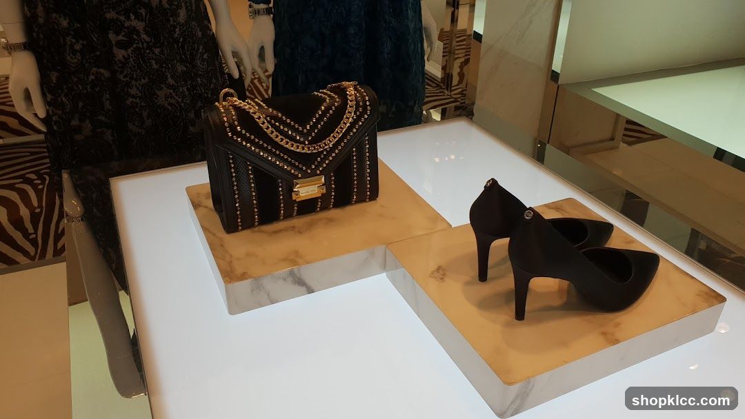 Black handbag and heels on display
