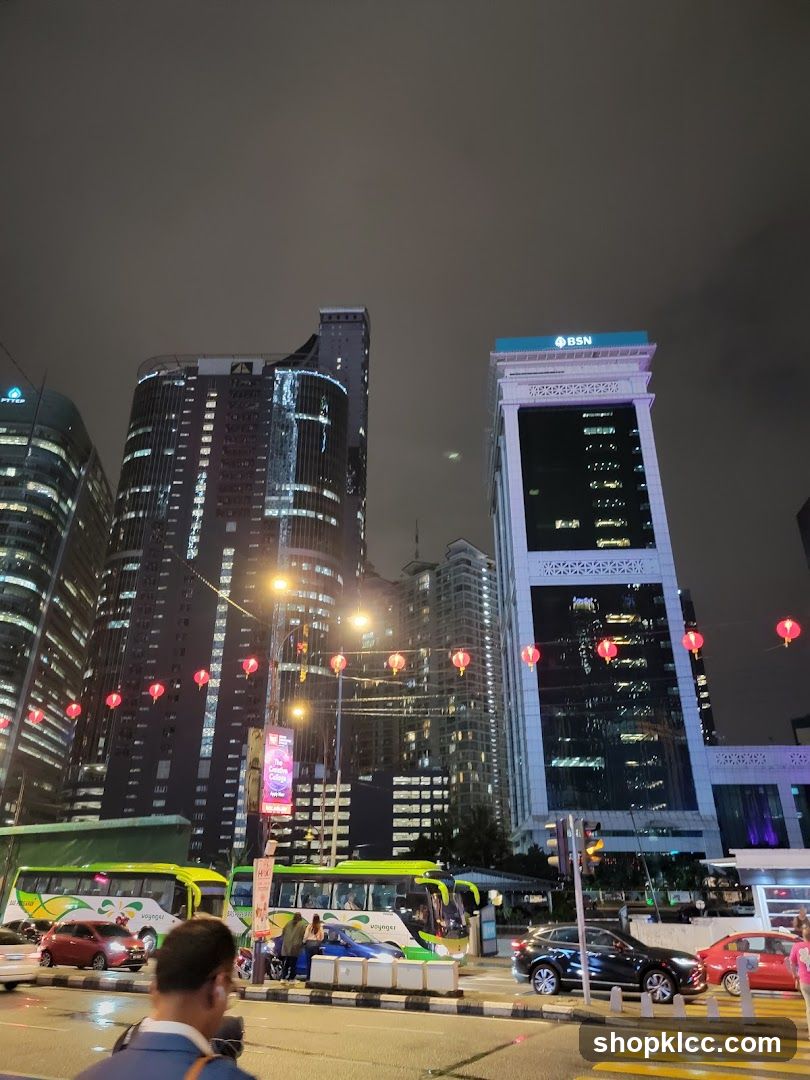 Cityscape at Night with Buses and Buildings