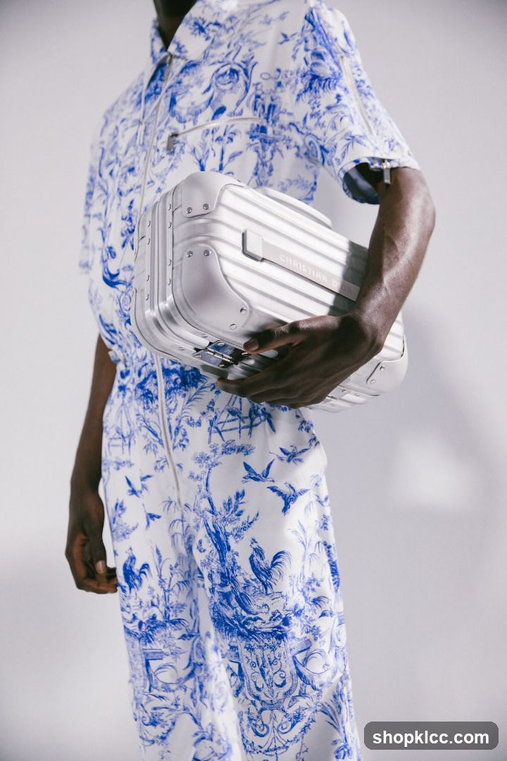 Man in Dior Jumpsuit Holding a Dior Suitcase