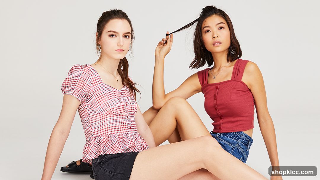 Two young women posing in casual tops