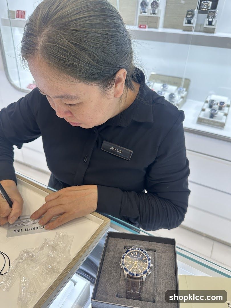 Salesperson writing on a tag next to a watch