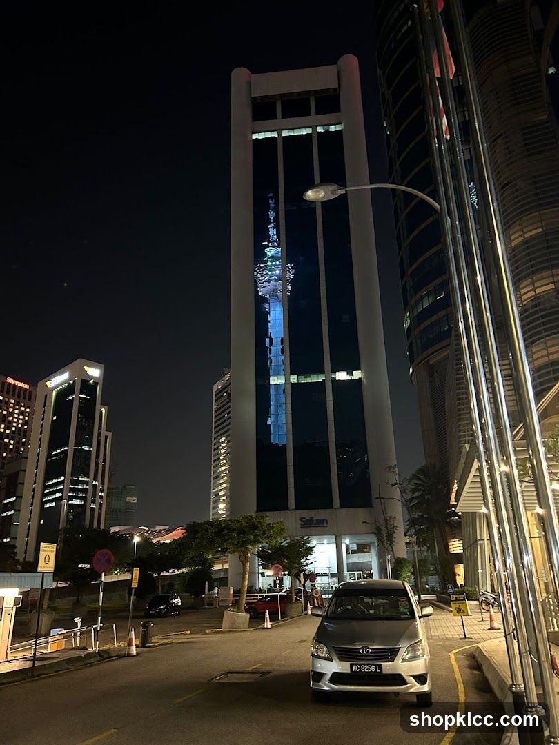 Nighttime Cityscape with Tall Buildings and a Car