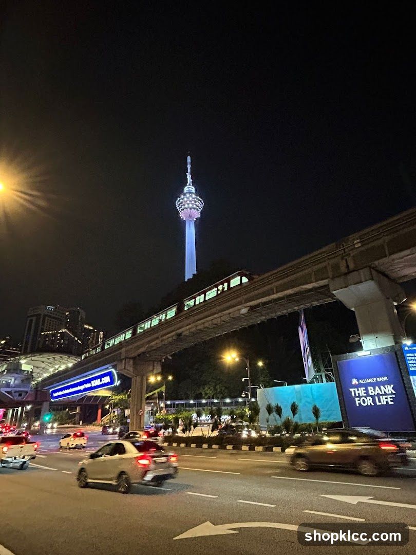 Cityscape at Night with Monorail and Tower