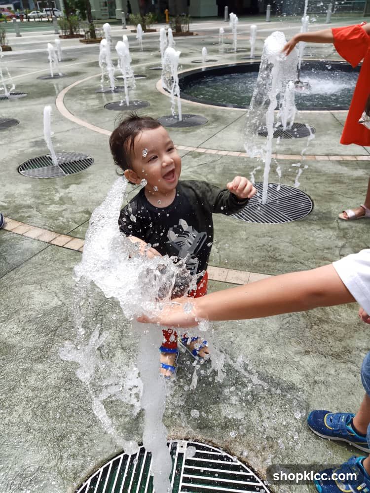 Children playing in a water fountain