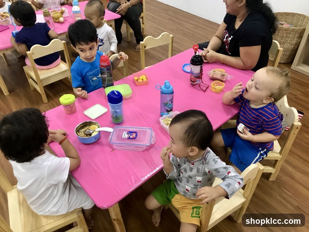 Children eating at a pink table