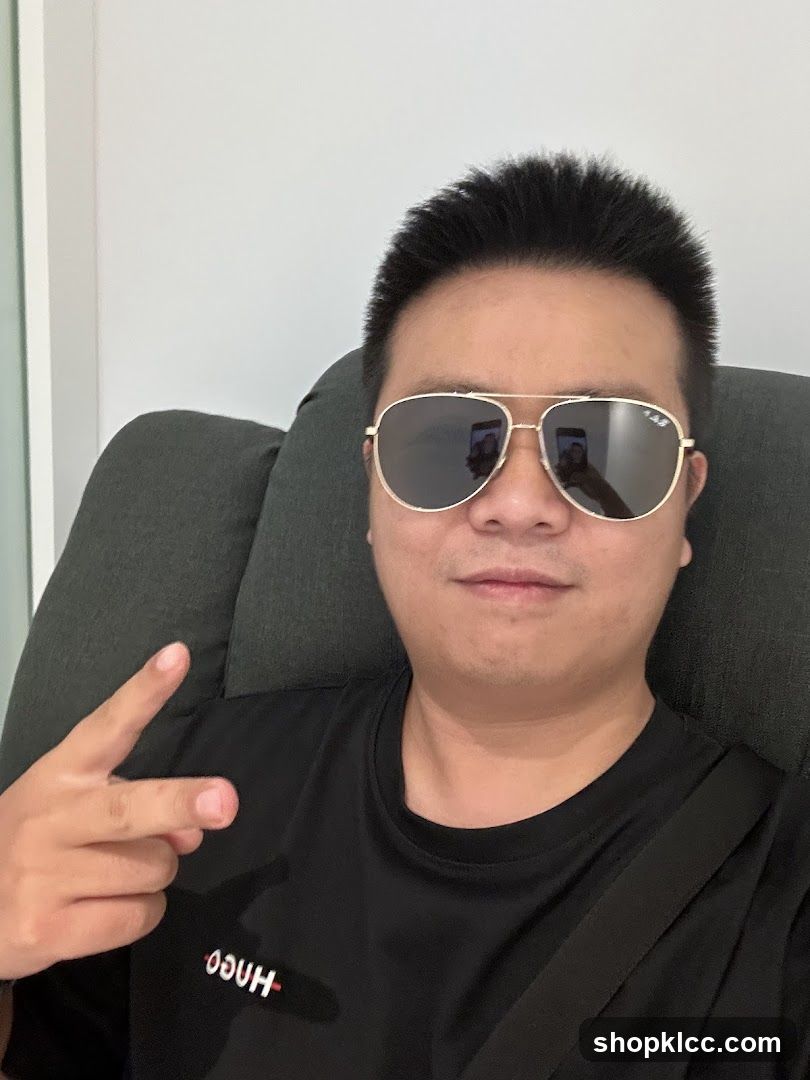 Man wearing sunglasses and a black t-shirt
