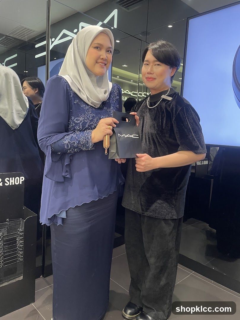 Two people posing in a MAC Cosmetics store
